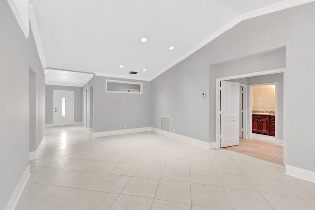 interior space featuring visible vents, baseboards, crown molding, light tile patterned flooring, and lofted ceiling