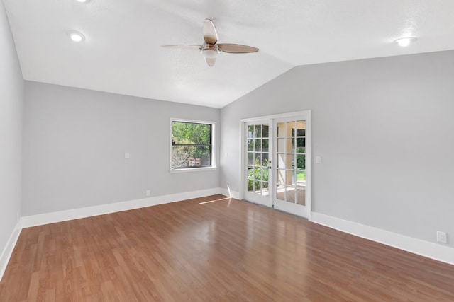 unfurnished room featuring wood finished floors, baseboards, a ceiling fan, and lofted ceiling