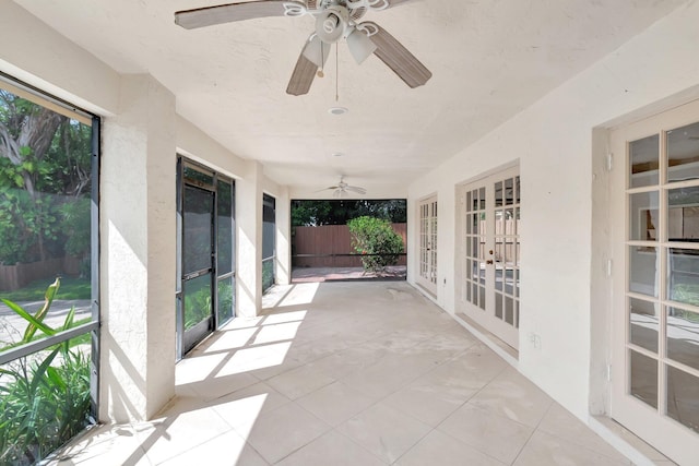 exterior space featuring french doors, fence, and a ceiling fan