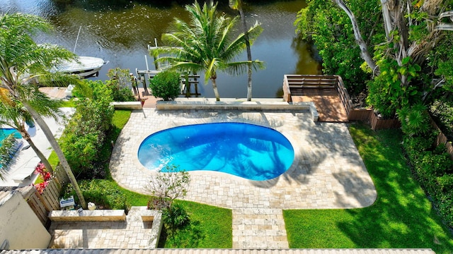 view of swimming pool featuring a swimming pool, a patio, and a water view