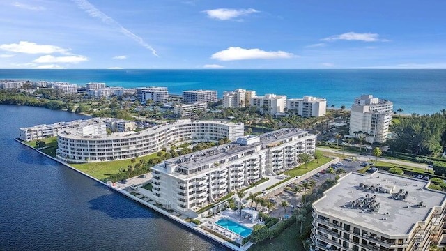 birds eye view of property featuring a city view and a water view