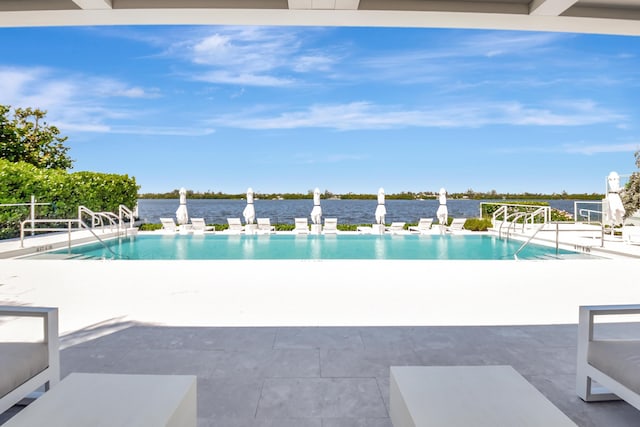 community pool featuring a water view and a patio area