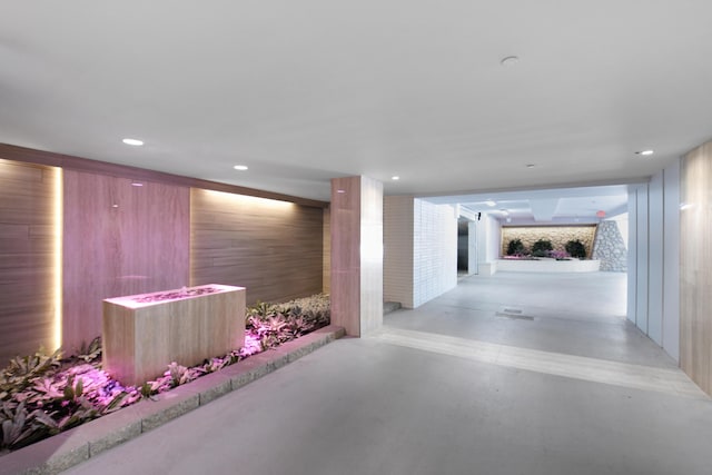 hallway with recessed lighting and finished concrete flooring