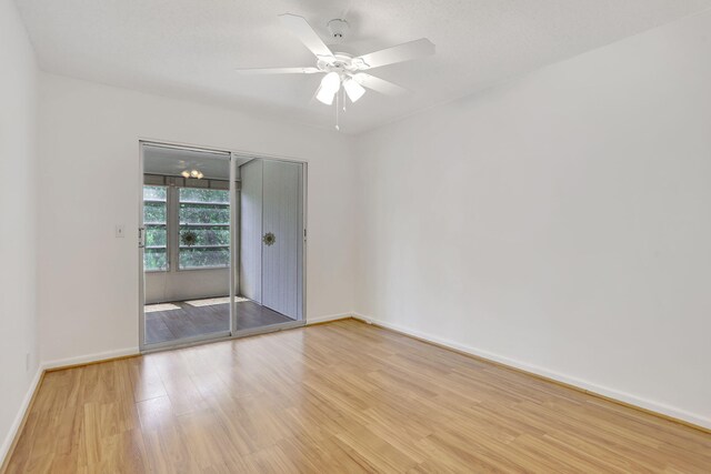 3034 Oakridge D 3034, Deerfield Beach, FL 33442 - empty room with light wood finished floors, baseboards, and ceiling fan