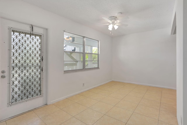 3034 Oakridge D 3034, Deerfield Beach, FL 33442 - empty room featuring ceiling fan, a textured ceiling, baseboards, and tile patterned flooring