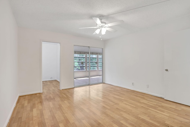 3034 Oakridge D 3034, Deerfield Beach, FL 33442 - empty room with ceiling fan, light wood-style floors, baseboards, and a textured ceiling