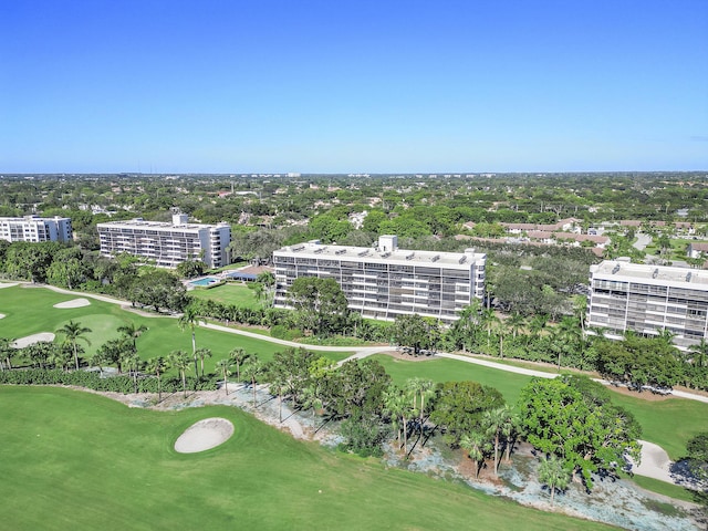 drone / aerial view with a city view and view of golf course