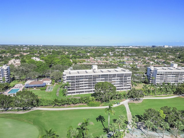 drone / aerial view featuring view of golf course and a view of city