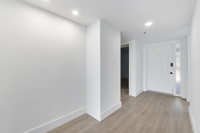 foyer featuring baseboards, recessed lighting, and light wood-style floors