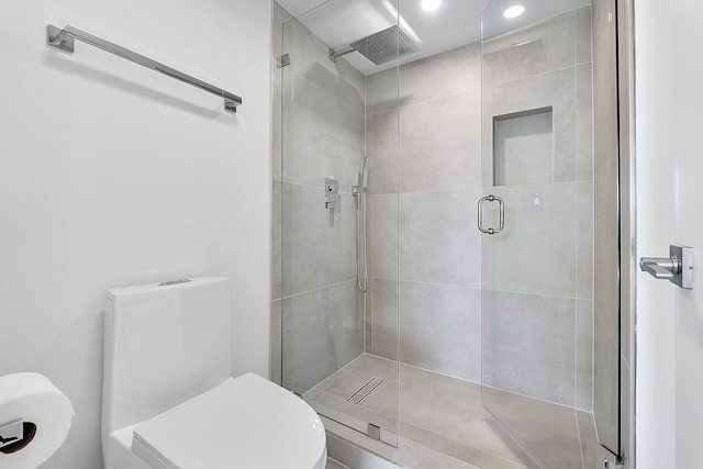 full bathroom featuring toilet and a shower stall