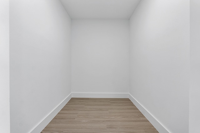 spare room featuring light wood-style flooring and baseboards