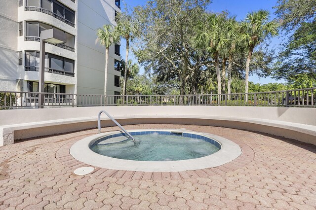 view of swimming pool with a community hot tub