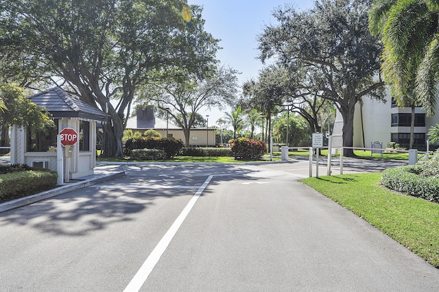 view of road with a gated entry and traffic signs