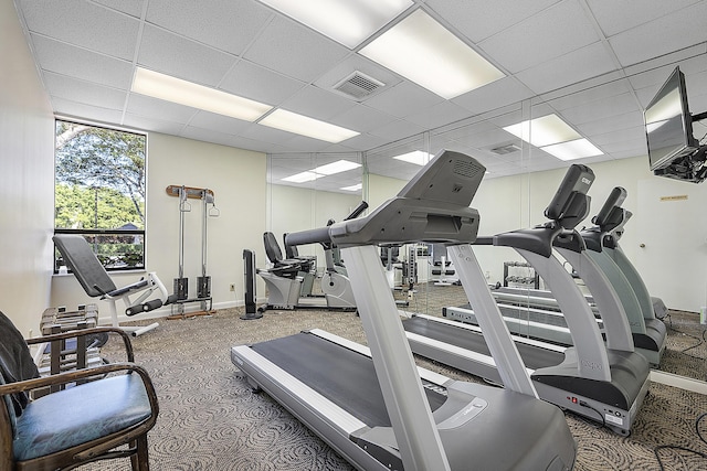 gym with visible vents, baseboards, and a paneled ceiling