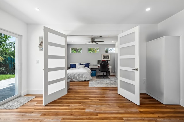 bedroom featuring light wood-type flooring, recessed lighting, and access to exterior