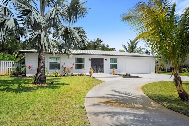 ranch-style house with fence, a front yard, driveway, and a garage