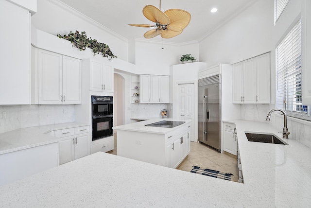 kitchen featuring open shelves, a sink, crown molding, black appliances, and light stone countertops
