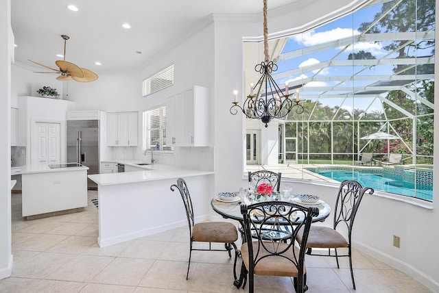 dining room featuring crown molding, light tile patterned floors, ceiling fan, and plenty of natural light