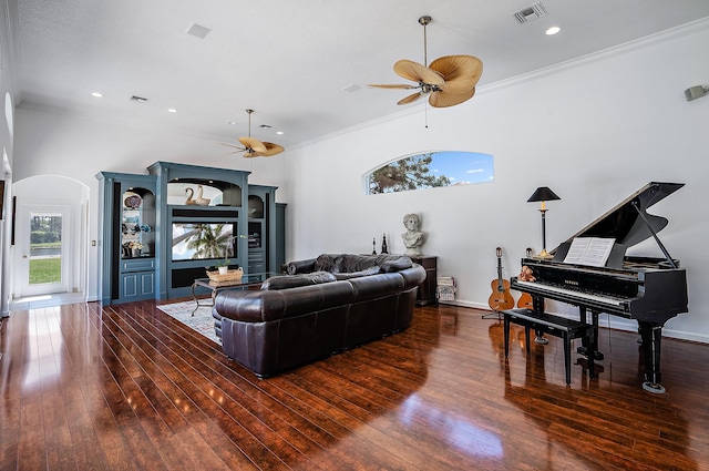 living area with visible vents, a ceiling fan, arched walkways, and hardwood / wood-style floors