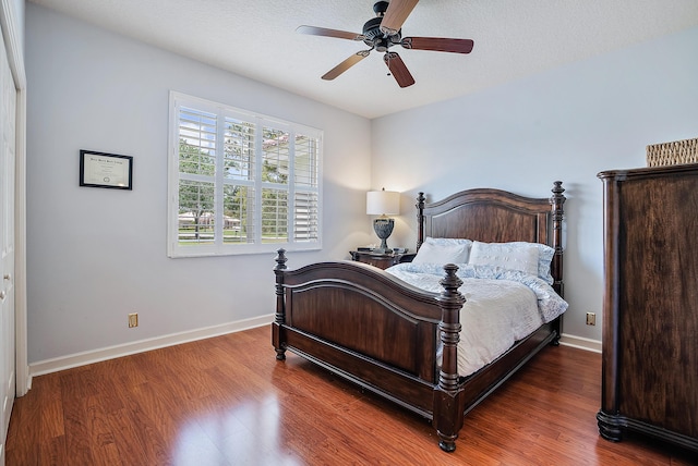 bedroom featuring wood finished floors, ceiling fan, and baseboards