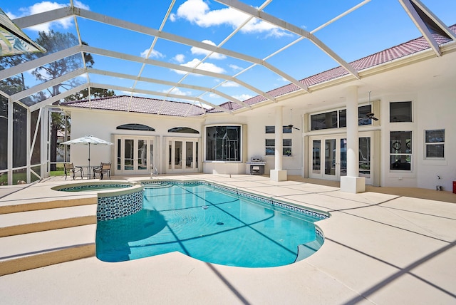 view of swimming pool featuring area for grilling, a pool with connected hot tub, a patio, a lanai, and french doors