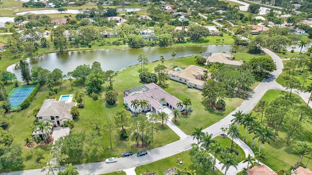 drone / aerial view with a water view and a residential view