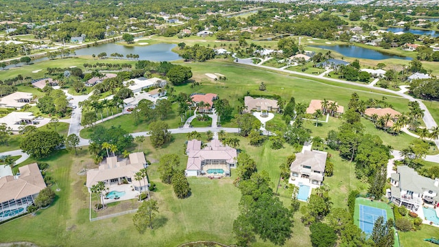 birds eye view of property featuring a water view, view of golf course, and a residential view