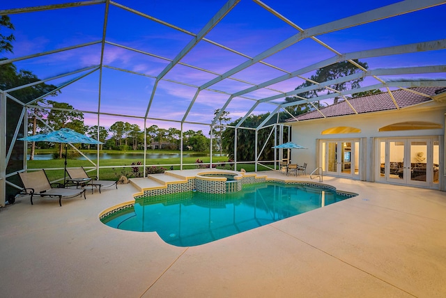 view of pool featuring a water view, a pool with connected hot tub, glass enclosure, a patio, and french doors