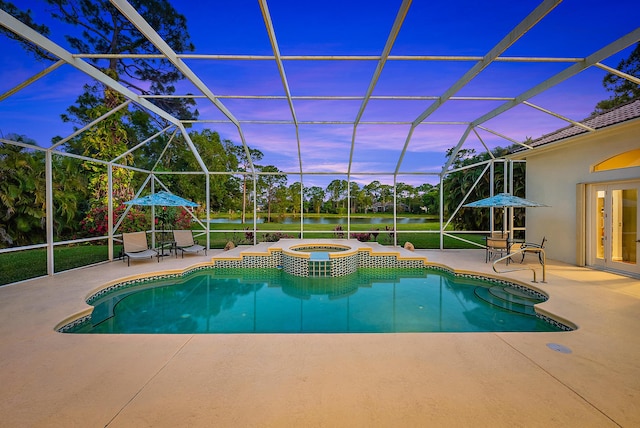 view of pool with a patio area, a pool with connected hot tub, and glass enclosure