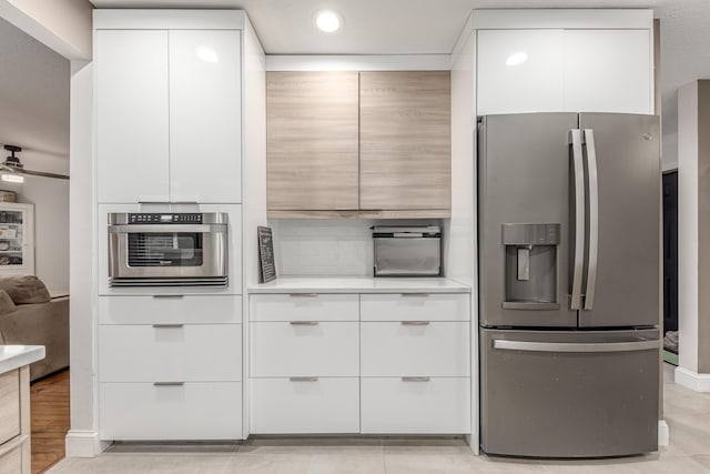 kitchen with white cabinetry, stainless steel appliances, modern cabinets, and light countertops