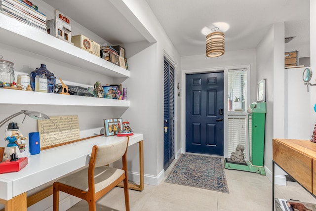 tiled foyer entrance with baseboards
