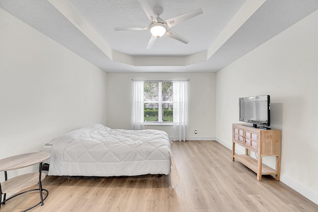 6298 Via Primo St, Lake Worth, FL 33467 - bedroom featuring a tray ceiling, light wood finished floors, baseboards, and ceiling fan