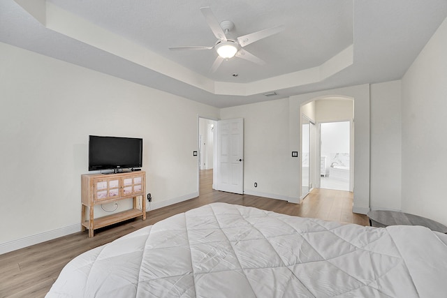 6298 Via Primo St, Lake Worth, FL 33467 - bedroom with a raised ceiling, arched walkways, wood finished floors, and baseboards