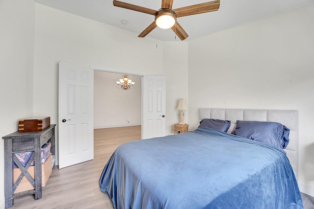 6298 Via Primo St, Lake Worth, FL 33467 - bedroom with a chandelier, light wood-style flooring, ceiling fan, and baseboards