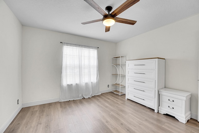 6298 Via Primo St, Lake Worth, FL 33467 - unfurnished bedroom featuring light wood-type flooring, baseboards, ceiling fan, and a textured ceiling