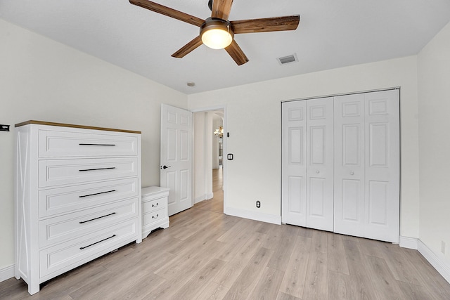 6298 Via Primo St, Lake Worth, FL 33467 - unfurnished bedroom with light wood finished floors, baseboards, a closet, and ceiling fan