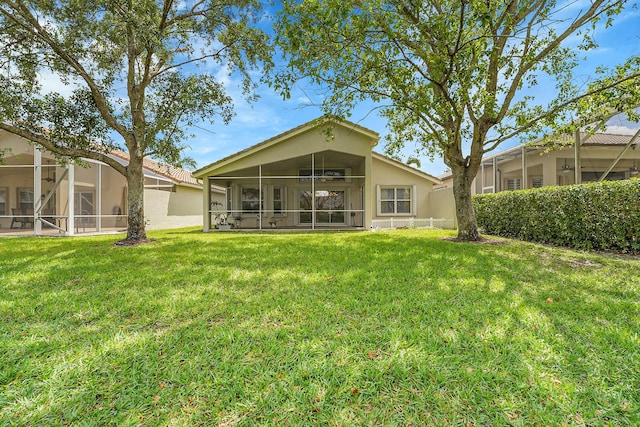 6298 Via Primo St, Lake Worth, FL 33467 - rear view of house with a yard, stucco siding, and a sunroom