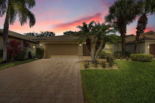 6298 Via Primo St, Lake Worth, FL 33467 - view of front facade featuring stucco siding, a tile roof, decorative driveway, and an attached garage