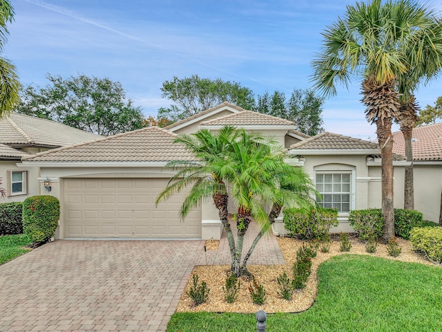 6298 Via Primo St, Lake Worth, FL 33467 - mediterranean / spanish-style home with stucco siding, a tiled roof, an attached garage, and driveway