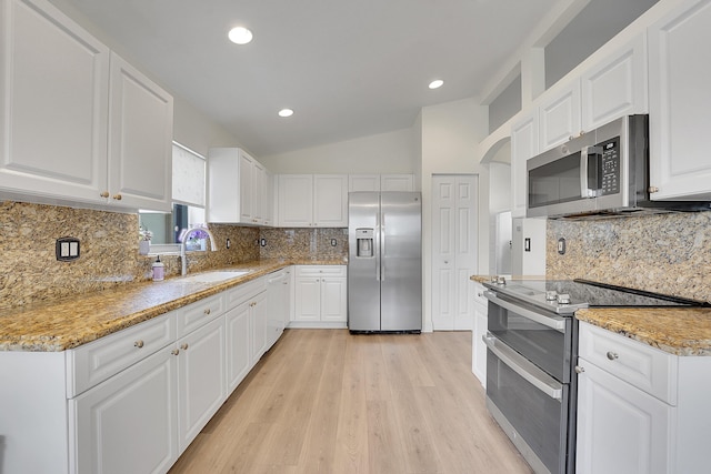 6298 Via Primo St, Lake Worth, FL 33467 - kitchen with appliances with stainless steel finishes, a sink, tasteful backsplash, light wood-type flooring, and recessed lighting
