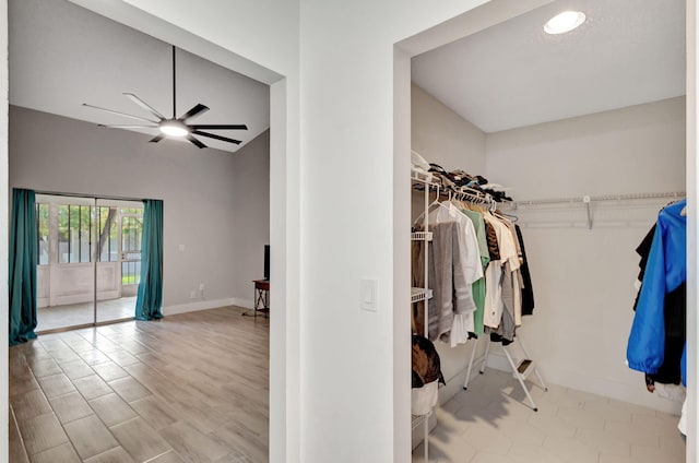 walk in closet featuring a ceiling fan