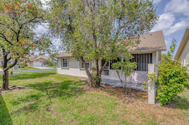 view of front of home featuring stucco siding and a front lawn