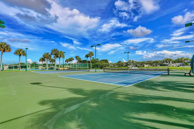 view of tennis court featuring fence