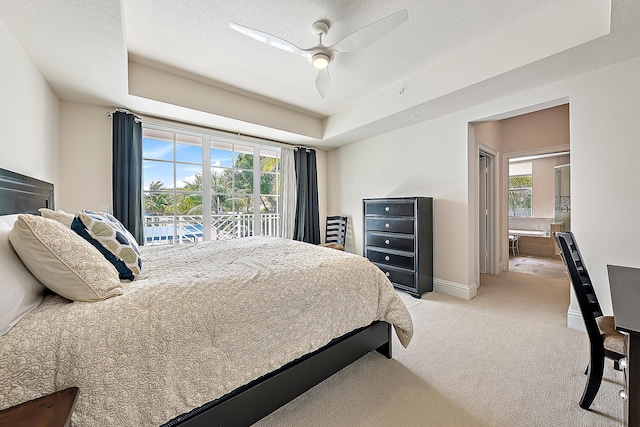621 Bay Colony Drive S & Slip 13, Juno Beach, FL 33408 - bedroom featuring a raised ceiling, multiple windows, light carpet, and access to exterior
