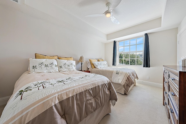 621 Bay Colony Drive S & Slip 13, Juno Beach, FL 33408 - bedroom with light carpet, baseboards, a ceiling fan, and a raised ceiling
