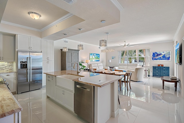 621 Bay Colony Drive S & Slip 13, Juno Beach, FL 33408 - kitchen with stainless steel appliances, a sink, ornamental molding, light tile patterned flooring, and ceiling fan