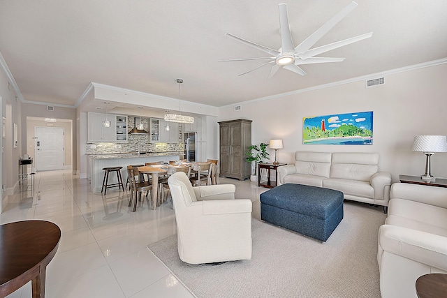 621 Bay Colony Drive S & Slip 13, Juno Beach, FL 33408 - living room with crown molding, a ceiling fan, light tile patterned flooring, and baseboards