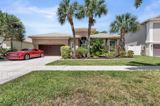2111 Bellcrest Ct, Royal Palm Beach, FL 33411 - view of front of home with an attached garage, decorative driveway, a tiled roof, and stucco siding