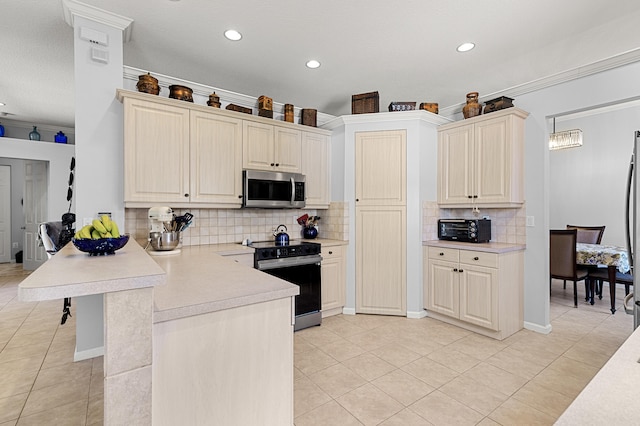 2111 Bellcrest Ct, Royal Palm Beach, FL 33411 - kitchen with stainless steel microwave, electric stove, a peninsula, light countertops, and recessed lighting