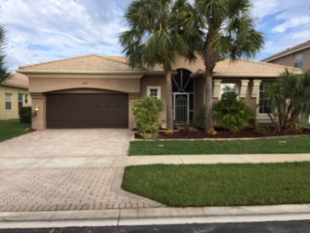 2111 Bellcrest Ct, Royal Palm Beach, FL 33411 - view of front of home with decorative driveway, a garage, stucco siding, and a front yard